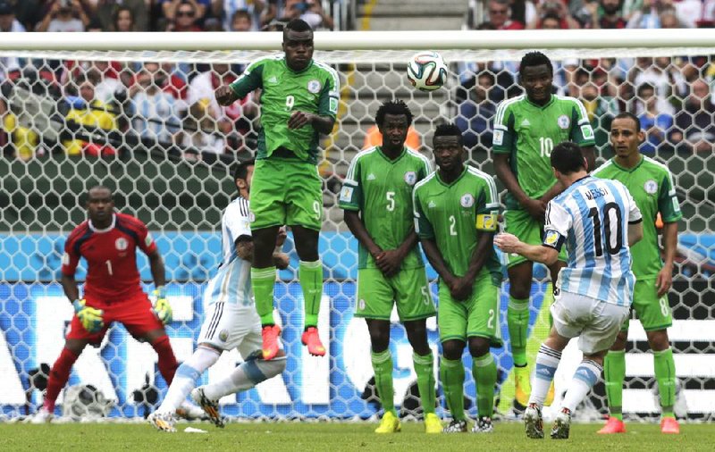 Argentina’s Lionel Messi (10) scores his team’s second goal on a free kick during first-half stoppage time in a Group F match against Nigeria on Wednesday in Porto Alegre, Brazil. Messi also scored early in the first half in Argentina’s 3-2 victory.