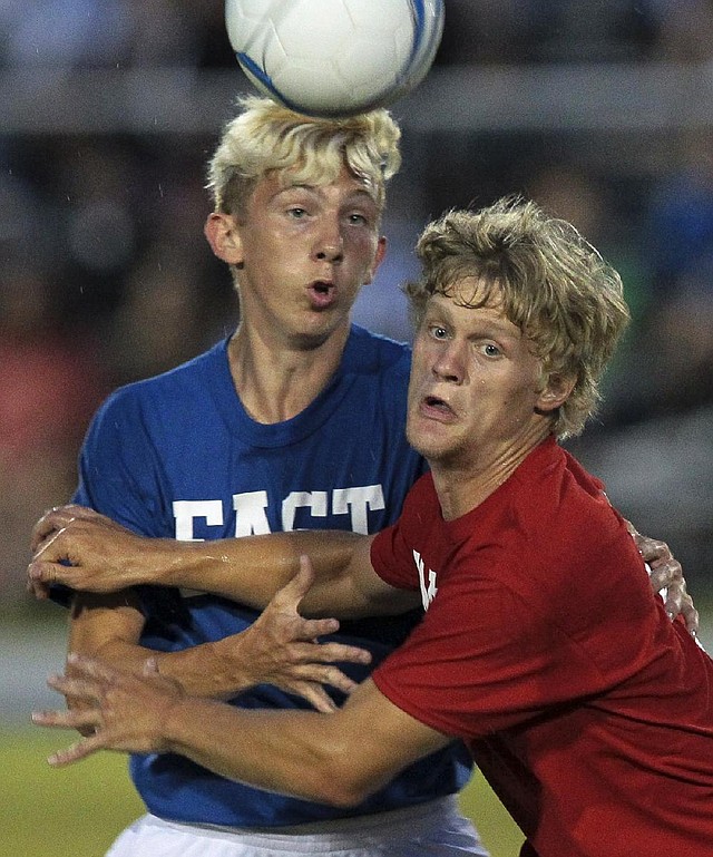 Harrison’s Andrew Matthews (right) of the West All-Stars defends against the East’s Dusty Gibson of Nettleton in the boys soccer game Wednesday night in Conway.