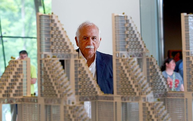 Architect Moshe Safdie stands behind a model, Urban Window Habitat, on Wednesday during a tour of the “Global Citizen:The Architecture of Moshe Safdie” exhibit at the Crystal Bridges Museum of American Art in Bentonville. The temporary exhibit is on display through Sept. 1.