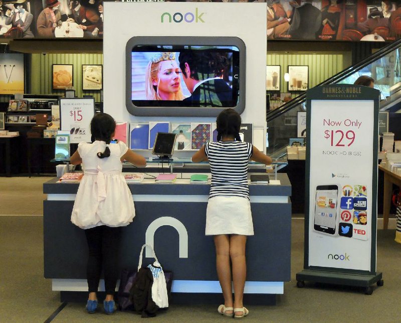 Customers look at Nook tablets at a Barnes & Noble store in Pineville, N.C., in this file photo. Barnes & Noble announced plans Wednesday to split into two separate companies.