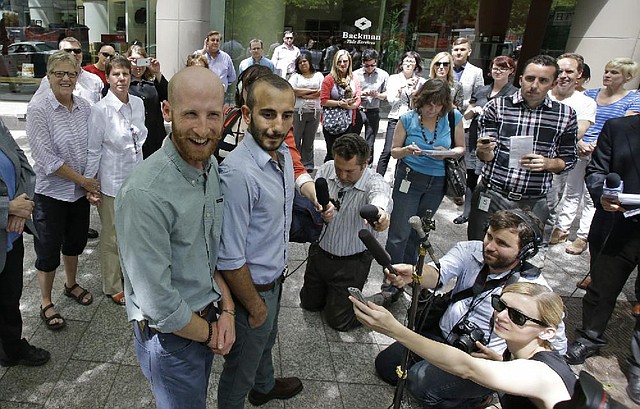 Derek Kitchen (left) and his partner, Moudi Sbeity, appear at a news conference Wednesday in Salt Lake City after a federal appeals court ruling allowing same-sex marriage in Utah and the five other states covered in the 10 U.S. Circuit Court of Appeals. However, the court stayed the ruling pending an appeal. 