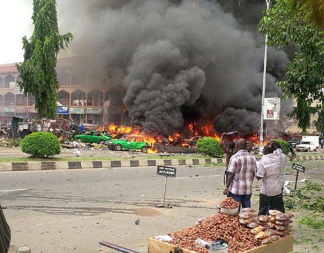 Smoke billows from a shopping mall Wednesday in the Nigerian capital of Abuja after a bomb blamed on Islamic extremists exploded, killing at least 21 people. The bomb, which went off as Nigerians prepared to watch their national soccer team play Argentina in the World Cup, is the latest in a series of deadly attacks attributed to the Boko Haram militant group.