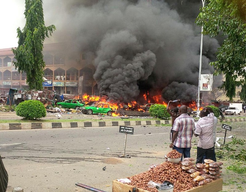 Smoke billows from a shopping mall Wednesday in the Nigerian capital of Abuja after a bomb blamed on Islamic extremists exploded, killing at least 21 people. The bomb, which went off as Nigerians prepared to watch their national soccer team play Argentina in the World Cup, is the latest in a series of deadly attacks attributed to the Boko Haram militant group.