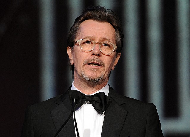 This Jan. 4, 2014 file photo shows actor Gary Oldman speaking at the Palm Springs International Film Festival Awards Gala at the Palm Springs Convention Center in Palm Springs, Calif. Oldman is defending fellow actors Mel Gibson and Alec Baldwin from critics of their comments on Jews and homosexuals, saying people need to take a joke. In an interview with Playboy, Oldman decried "political correctness" that ensnared the two actors. 
