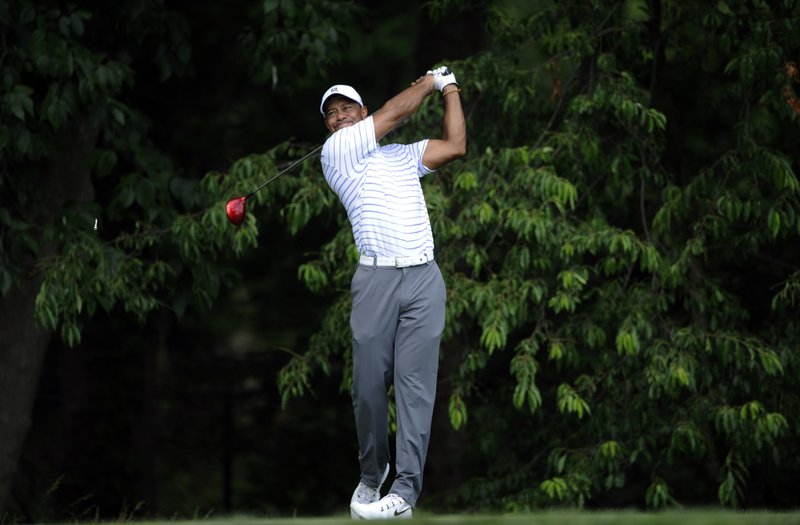 Tiger Woods watches his tee shot on the sixth hole during the Pro-Am at the Quicken Loans National golf tournament, Wednesday, June 25, 2014, in Bethesda, Md. 