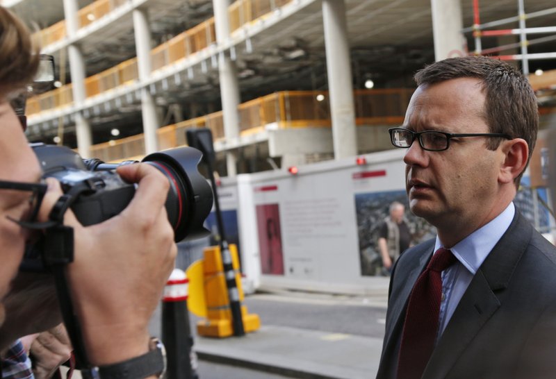Andy Coulson, right, former News of the World editor, arrives at the Central Criminal Court in London, Wednesday, June 25, 2014. Coulson was convicted of phone hacking Tuesday, but fellow editor Rebekah Brooks was acquitted after a months long trial centering on illegal activity at the heart of Rupert Murdoch's newspaper empire. A jury at London's Old Bailey unanimously found Coulson, the former spin doctor of British Prime Minister David Cameron, guilty of conspiring to intercept communications. The nearly eight-month trial was triggered by revelations that for years the News of the World used illegal eavesdropping to get stories, listening in on the voicemails of celebrities, politicians and even crime victims.