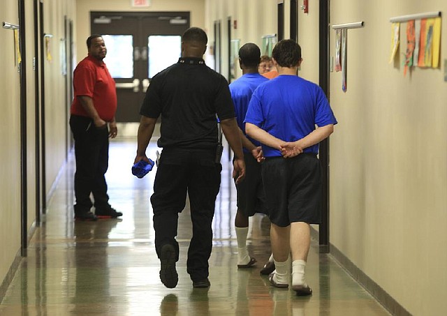 2014 FILE PHOTO: Staff members escort boys between classrooms at the Arkansas Juvenile Assessment and Treatment Center near Alexander. 