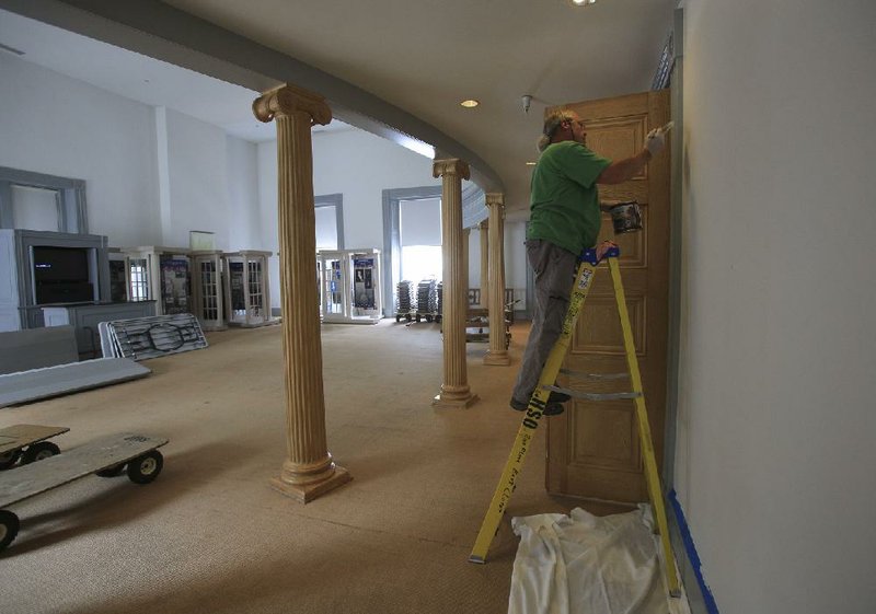  Arkansas Democrat-Gazette/STATON BREIDENTHAL --6/26/14--  Mike Dauzat (cq) of the Old Statehouse staff paints a wall in an room that will be used for overflow seating Thursday as preparations continue for next weeks special session. 