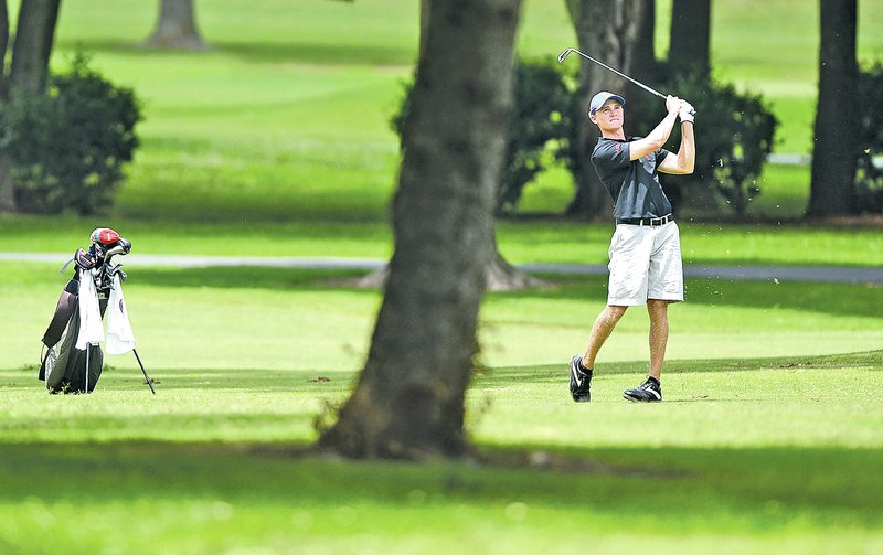  STAFF PHOTO SAMANTHA BAKER &#8226; @NWASAMANTHA Kyler Tate of Winter Garden, Fla., hits from the 17th fairway Thursday at Lost Springs Golf Course in Rogers during the KPMG Stacy Lewis Junior Open.