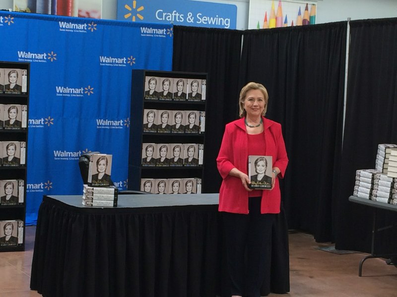 Hillary Clinton poses with her new book, "Hard Choices," on Friday, June 27, 2014 at a west Little Rock Wal-Mart.