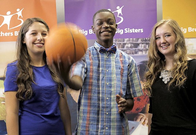 Anna Bliss Deen (from left), Kahleel Jones and Maddie Spence play around with a basketball at the Big Brothers Big Sisters office in North Little Rock.