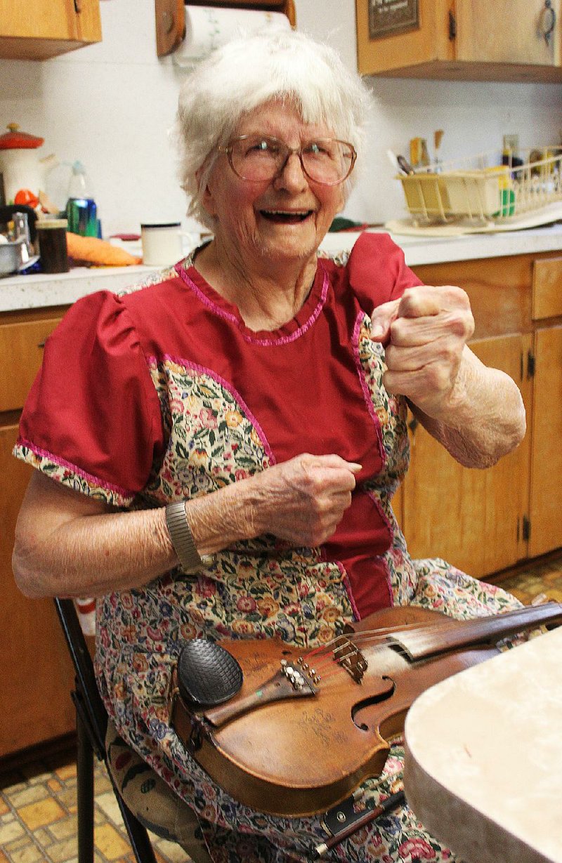 Arkansas Democrat-Gazette/FRANK FELLONE - 
At 97, Violet Hensley is proud of her strong grip, developed and maintained by a life of hard work. A luthier, or maker of fiddles, Hensley was named an Arkansas Living Treasure in 1994 by the Arkansas Arts Council. The award honors Arkansans who have been outstanding in the creation of a traditional craft and have significantly contributed to its preservation.