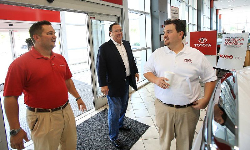 Arkansas Democrat-Gazette/ STATON BREIDENTHAL --8/28/12-- Steve Landers Sr. (middle) with sons Steve Landers Jr. and Scott Landers (right) at their Toyota dealership in Little Rock. 