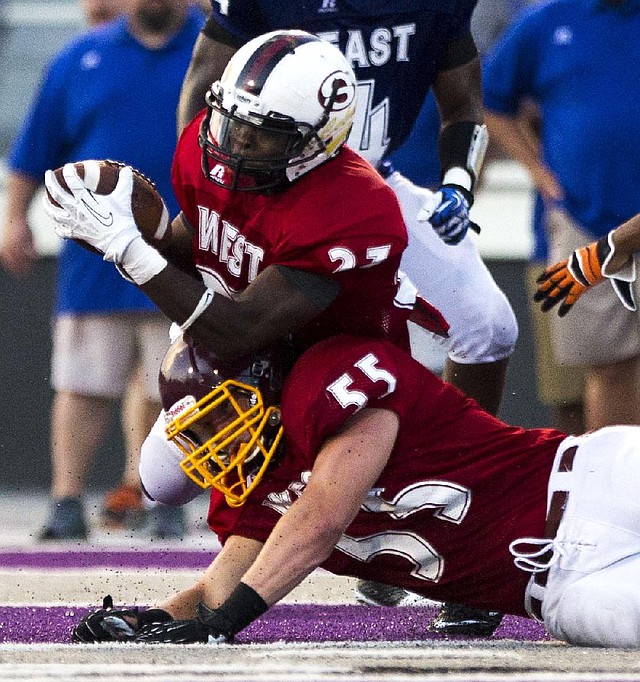 Arkansas Democrat-Gazette/MELISSA SUE GERRITS - 06/27/2014 -  West's Qua Rose snags an interception and struggles to keep to his feet with team mate Chris Eastburn defending during the High School All Star football game June 27, 2014 at UCA in Conway. 