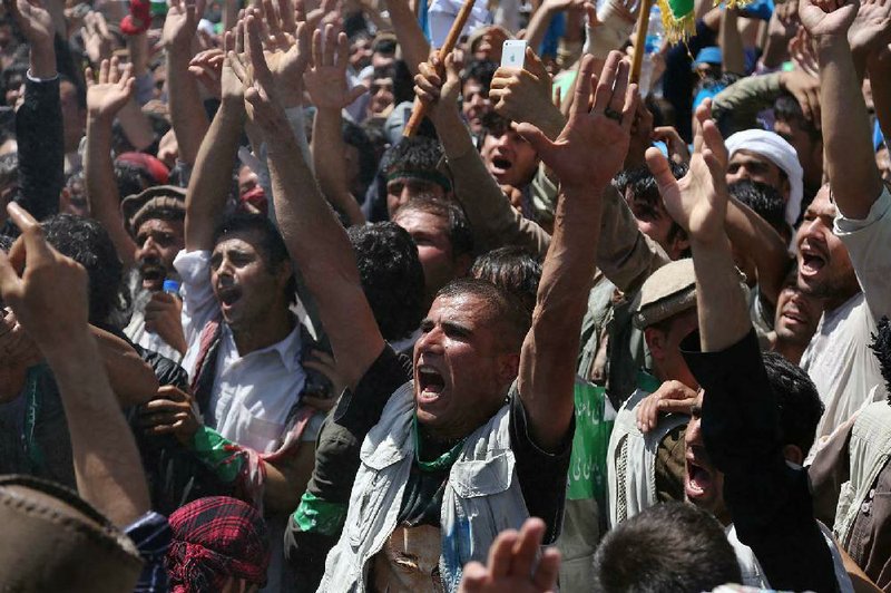 Supporters of Afghan presidential candidate Abdullah Abdullah chant slogans during a protest in Kabul, Afghanistan, Friday, June 27, 2014. Afghanistan's security situation has been complicated by a political crisis stemming from allegations of massive fraud in the recent election to replace President Hamid Karzai, the only leader the country has known since the Taliban regime was ousted nearly 13 years ago. Abdullah Abdullah, one of two candidates who competed a runoff vote on June 14 suspended his relations with the Independent Election Commission after he accused electoral officials of engineering extensive vote rigging, allegations they have denied. (AP Photo/Rahmat Gul)