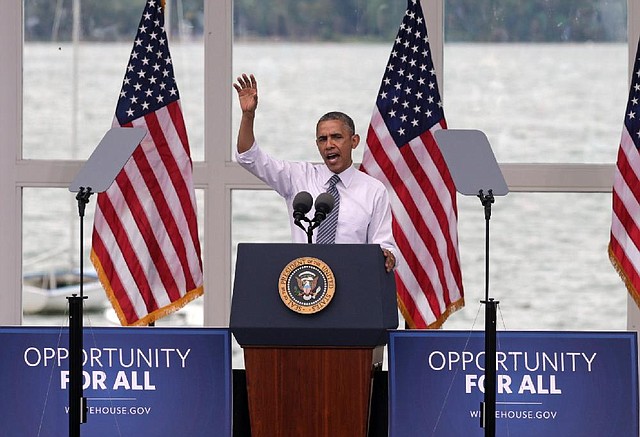 President Barack Obama gives an economic policy speech at the Lake Harriet Bandshell, Friday, June 27, 2014, in Minneapolis  for the first in a series of Day-in-the-Life visits that he plans to make across the country this summer. (AP Photo/Jim Mone)