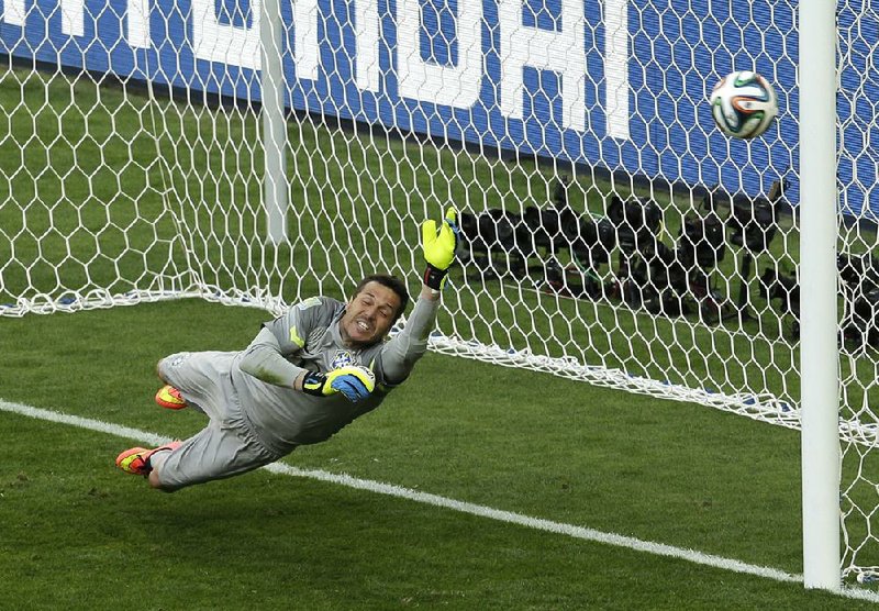 Julio Cesar, the Brazilian goalkeeper, comes up short in an attempt to block a penalty kick in extra time by Chile’s Gonzalo Jara on Saturday in Belo Horizonte, Brazil. Jara’s kick bounced off the goalpost and went far left of the goal, securing Brazil’s round of 16 victory. Cesar stopped three attempts in the penalty-kick phase.
