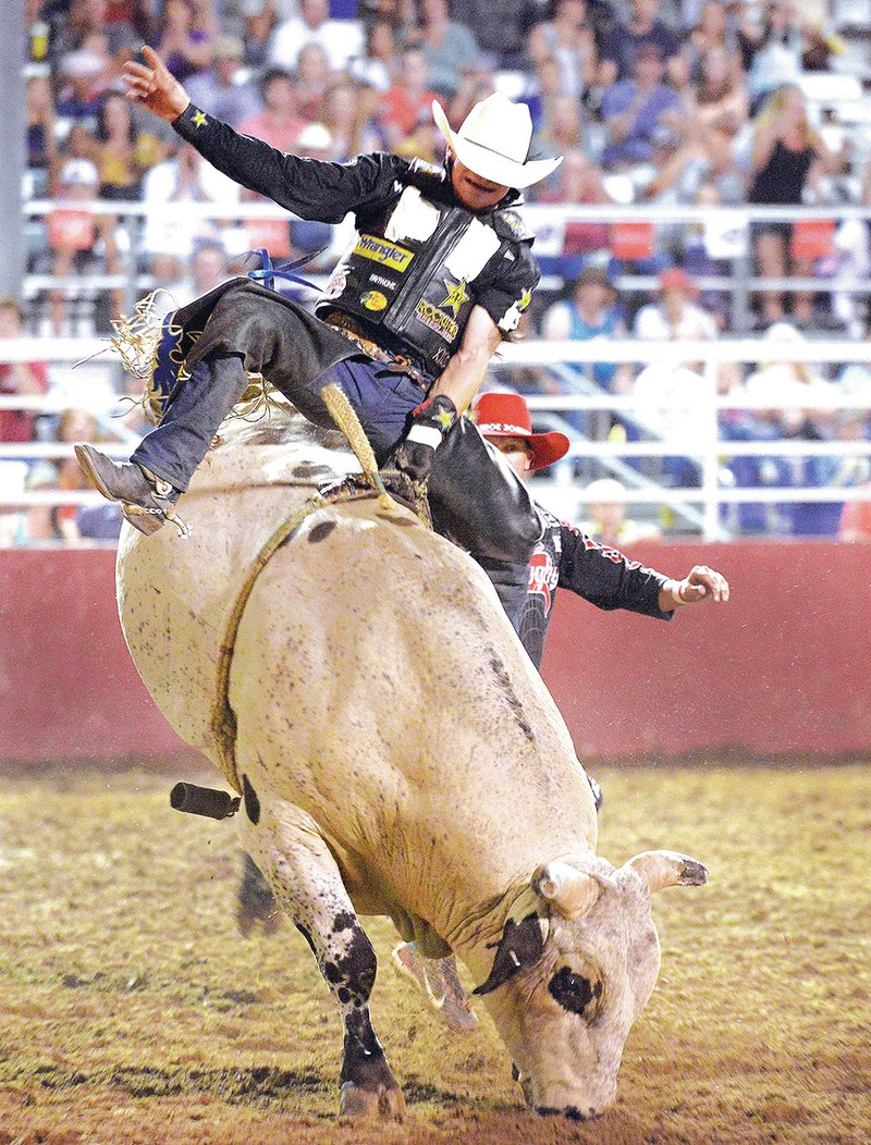 FILE PHOTO JASON IVESTER Chase Ethan Outlaw of Tily competes in the bull riding July 5 during the Rodeo of the Ozarks at Parsons Stadium in Springdale. Outlaw scored an 85 to lead all riders