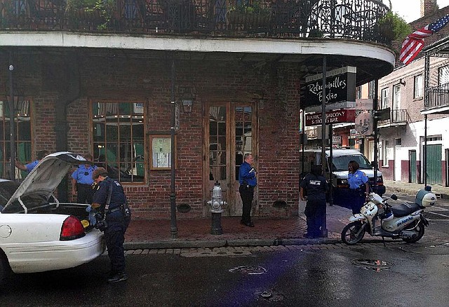 CORRECTS ACTIVITY SHOWN IN SCENE - Authorities continue working the scene along Bourbon Street after a shooting, early Sunday, June 29, 2014, in New Orleans. Nine people were shot on Bourbon Street in New Orleans' celebrated French Quarter, leaving at least one person in critical condition. (AP Photo/NOLA.com/The Times-Picayune, Benjamin Alexander-Bloch) MAGS OUT; NO SALES; USA TODAY OUT; THE BATON ROUGE ADVOCATE OUT