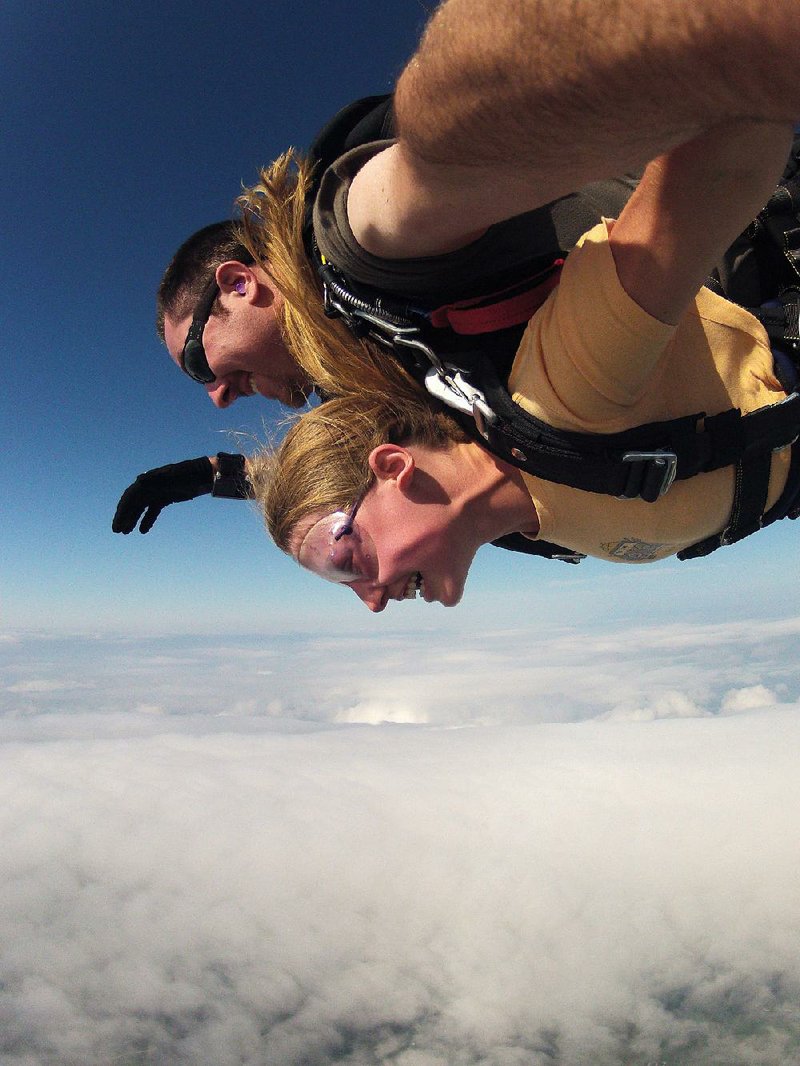 Special to the Democrat-Gazette/Brad Barnett
Olivia Caillouet and her jumping instructor Brad Barnett leave Skydive Skyranch's plane June 17.