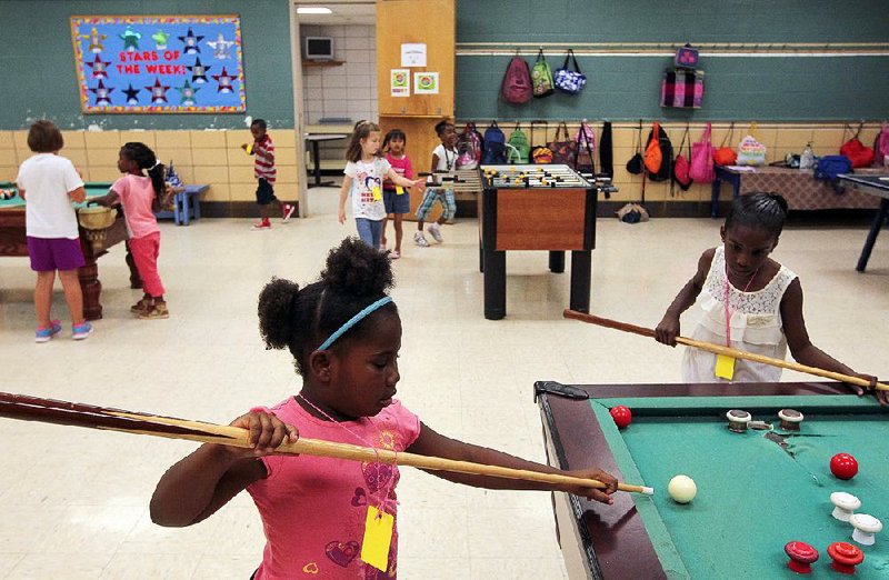 Arkansas Democrat-Gazette/BENJAMIN KRAIN --06/26/14--
Olivia Boyd, center, and Malaya Vanpelt, right, are some of the 350 kids attending the North Little Rock Wetherington Boys and Girls Club summer program. The city has notified the club and other nonprofit organizations that funding is likely to be cut next year. Currently the Boys Club fees are only $85 per child for the 3 month summer program.