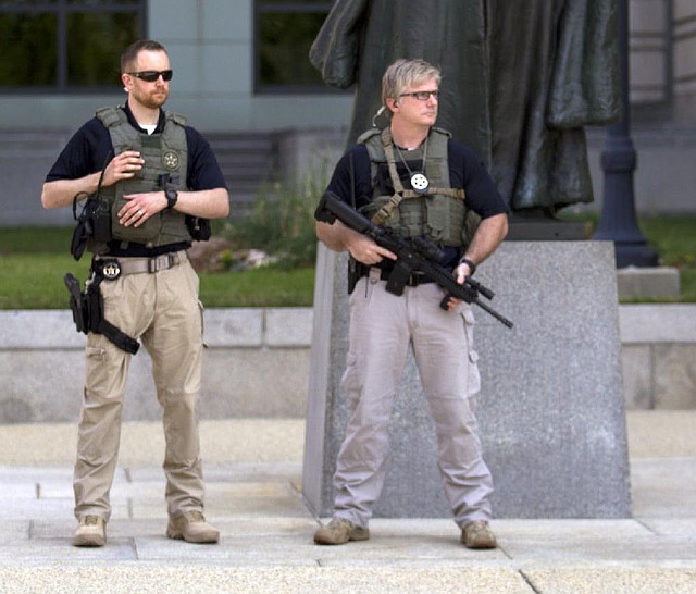 U.S. marshals keep watch Saturday around the federal courthouse in Washington as part of increased security before Ahmed Abu Khattala’s court appearance before a federal magistrate.