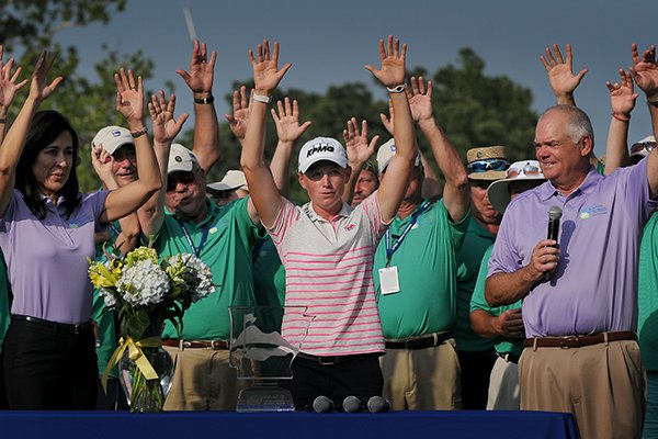 Stacy Lewis, right, holds up the trophy during a ceremony on the 18th green following the final round of the Walmart NW Arkansas Championship presented by P&G at Pinnacle Country Club in Rogers on Sunday, June 29, 2014.
