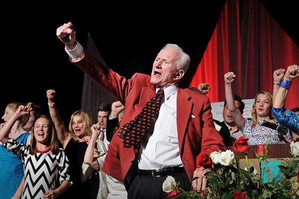 Frank Broyles, surrounded by his family, calls the hogs to close the evening during the 'Coach's Quarter: A Celebration of Coach Broyles' Life and Career' banquet at the John Q Hammons Center in Rogers on Saturday, June 7, 2014. 