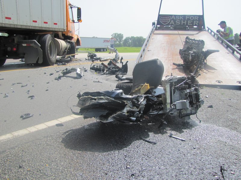 Parts of a motorcycle are loaded onto a wrecker Monday afternoon after a fatal accident involving a tractor-trailer on Sloane Drive in Little Rock. The motorcyclist was pronounced dead at the scene.