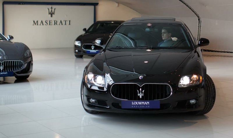 A salesman drives a Maserati Ghibli luxury automobile, produced by Maserati SpA, inside the Louwman Exclusive Cars showroom in Utrecht, Netherlands, on Tuesday, Jan. 28, 2014. Carmakers are predicting a gradual increase in European demand this year after a sovereign-debt crisis and recessions led to a six-year contraction in deliveries through 2013. Photographer: Jasper Juinen/Bloomberg