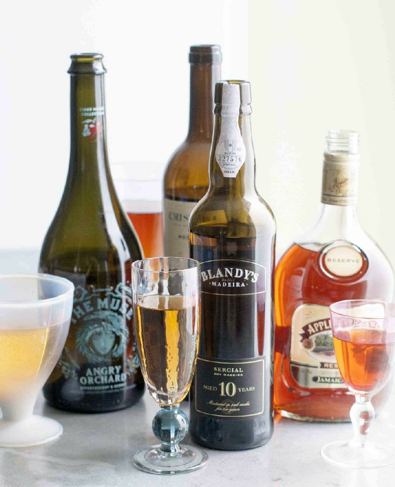 This June 2, 2014, photo shows, from left to right, The Muse Angry Orchard "gluten free" carbonated apple wine, Cristina Jerez Xeres Sherry, Blandy's Special Dry Madeira and Appleton Estate Reserve Jamaica Rum in Concord, N.H. (AP Photo/Matthew Mead)
