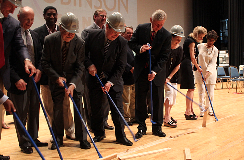 Officials including Arkansas Gov. Mike Beebe and Little Rock Mayor Mark Stodola pry boards from the Robinson Center stage in a ceremony marking the beginning of a 26-month renovation.