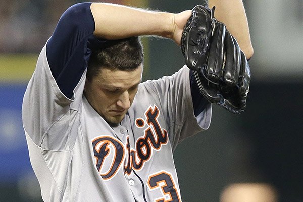 Detroit Tigers starting pitcher Drew Smyly wipes his head after giving up an RBI single to Houston Astros' Jesus Guzman in the first inning of a baseball game Sunday, June 29, 2014, in Houston. (AP Photo/Pat Sullivan)