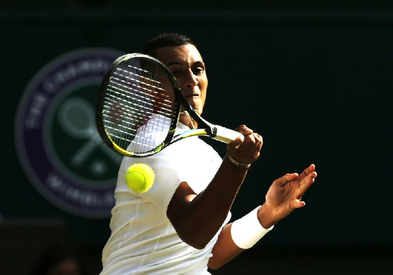 Nick Kyrgios of Australia returns a shot to No. 2 seed Rafael Nadal on Tuesday at Wimbledon on his way to a 7-6 (5), 5-7, 7-6 (5), 6-3 victory that included 37 aces.