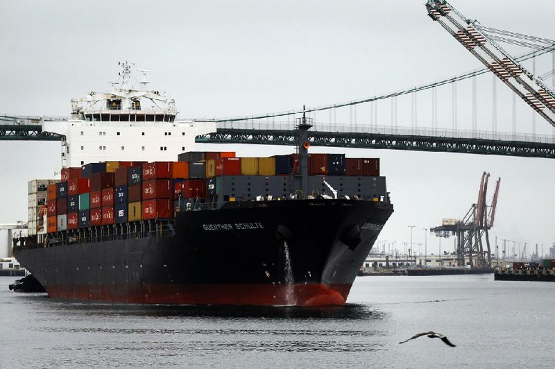 The Guenther Schulte container ship departs the Port of Los Angeles in San Pedro, Calif., on Monday. The expiration of a six-year labor contract between about 20,000 dockworkers and 29 West Coast ports threatens to disrupt trade as negotiators scramble to forge an agreement on salaries and health care costs.