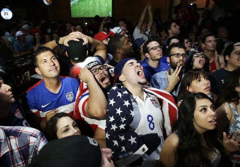 U.S. soccer fans at the Crown & Anchor British Pub in Las Vegas react Tuesday to a missed opportunity by the Americans during their World Cup soccer match against Belgium. U.S. soccer fans, including the president, gathered in front of TVs in bars, city parks, stadiums and at their work places to watch the afternoon match.