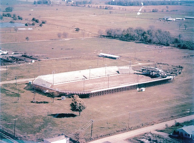 FILE PHOTO This undated photo shows an early version of Parsons Stadium. Taken from the west, the feed store and sale barn owned by Shorty Parsons and Dempsey Letsch and a few chicken houses are the only buildings in the the area. Today, this busy intersection at the corner of Emma Avenue and Old Missouri Road includes the Jones Center and the Springdale Municipal Airport.
