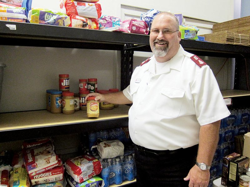 Maj. David Robinson, corps officer for The Salvation Army in Conway, shows the sparse shelves of the organization’s food pantry. He said the demand for food boxes has outpaced the supply, and donations of canned goods and other food items are needed. Debbie Hendrix, director of social services for The Salvation Army, said close to 100 food boxes are given out each week. Donations may be taken to The Salvation Army office in the North Plaza Shopping Center, 2125 Harkrider St., Suite 12, from 8 a.m. to noon and from 1-5 p.m. Monday through Friday.