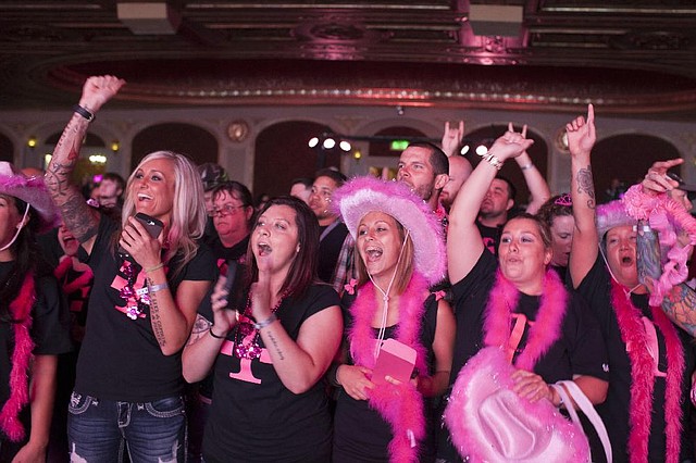 Attendees cheer at a T-Mobile US Inc. event at the Paramount Theatre in Seattle on June 18. Federal regulators have accused T-Mobile of wrongly charging customers for some services.