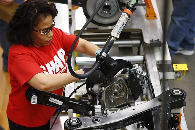 An assembly line worker builds a 2015 Chrysler 200 at the Sterling Heights Assembly Plant in Sterling Heights, Mich., in this file photo. Orders for durable goods fell 0.9 percent in May, the Commerce Department said Wednesday.