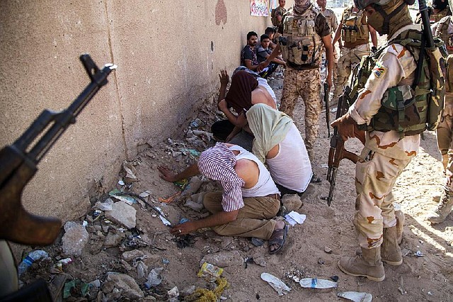 Iraqi security forces arrest followers of Shiite cleric Mahmoud al-Sarkhi after clashes Wednesday in the Shiite holy city of Karbala, 50 miles south of Baghdad.