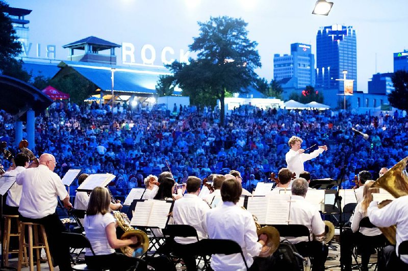 Philip Mann conducts the Arkansas Symphony Orchestra for last year’s Pops on the River. This year’s concert will incorporate a patriotic singalong and, for the first time, a joint symphony-fireworks performance.