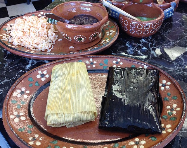 A combination plate, featuring Verde (right) and Oaxaqueno tamales and two sides (shown here: rice and beans), is $4.99 at Tamalittle in Little Rock.
