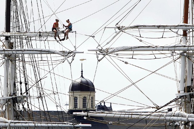 Crew members of the restored whaling ship Charles W. Morgan secure sails and lines Wednesday in New Bedford, Mass., in preparation for Tropical Storm Arthur. The storm is expected to grow into a hurricane off the North Carolina coast and track northward off shore.