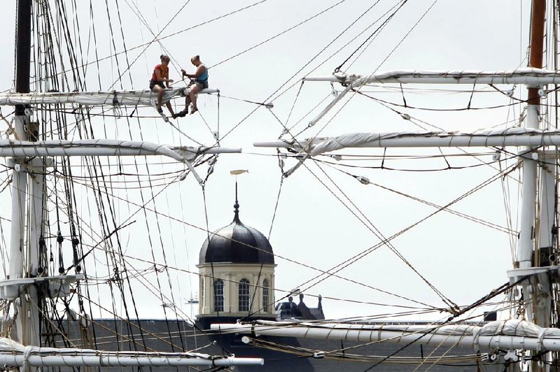 Crew members of the restored whaling ship Charles W. Morgan secure sails and lines Wednesday in New Bedford, Mass., in preparation for Tropical Storm Arthur. The storm is expected to grow into a hurricane off the North Carolina coast and track northward off shore.