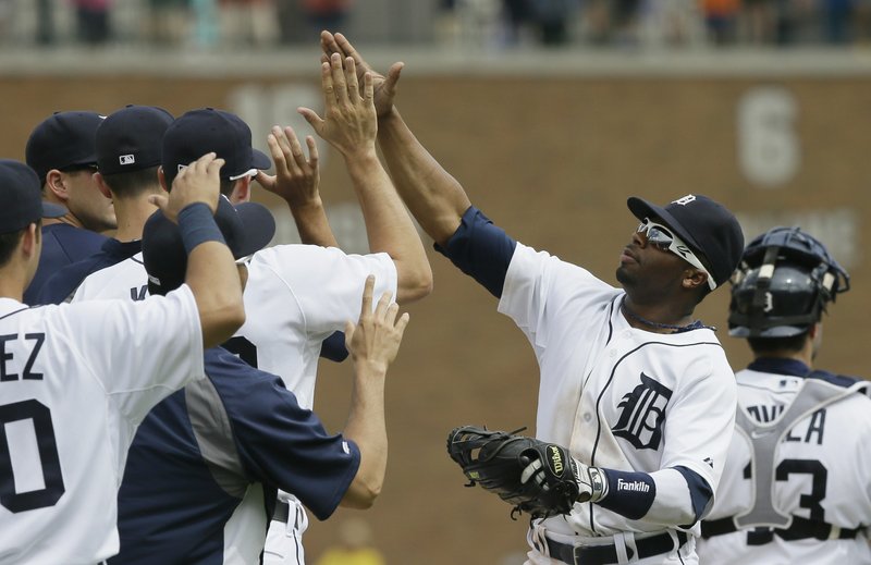 Detroit Tigers left fielder Rajai Davis celebrates with teammates after their 9-3 win over the Oakland Athletics in a baseball game in Detroit, Wednesday, July 2, 2014. 