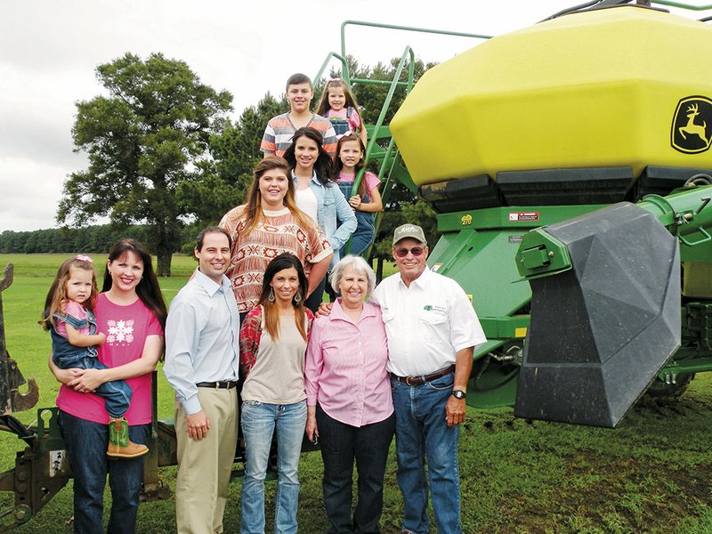 The Hervey Madden family of the Cowlake community has been named the 2014 Jackson County Farm Family of the Year. Family members include, standing, from the left, Susie Madden holding 3-year-old Bella, Mac Madden, Tracy Carter and Adele and Hervey Madden, and back, from the bottom to the top, Somer Carter, Starr Carter, Lola Madden, Austin Carter and Zoe Madden. The family raises rice and soybeans.