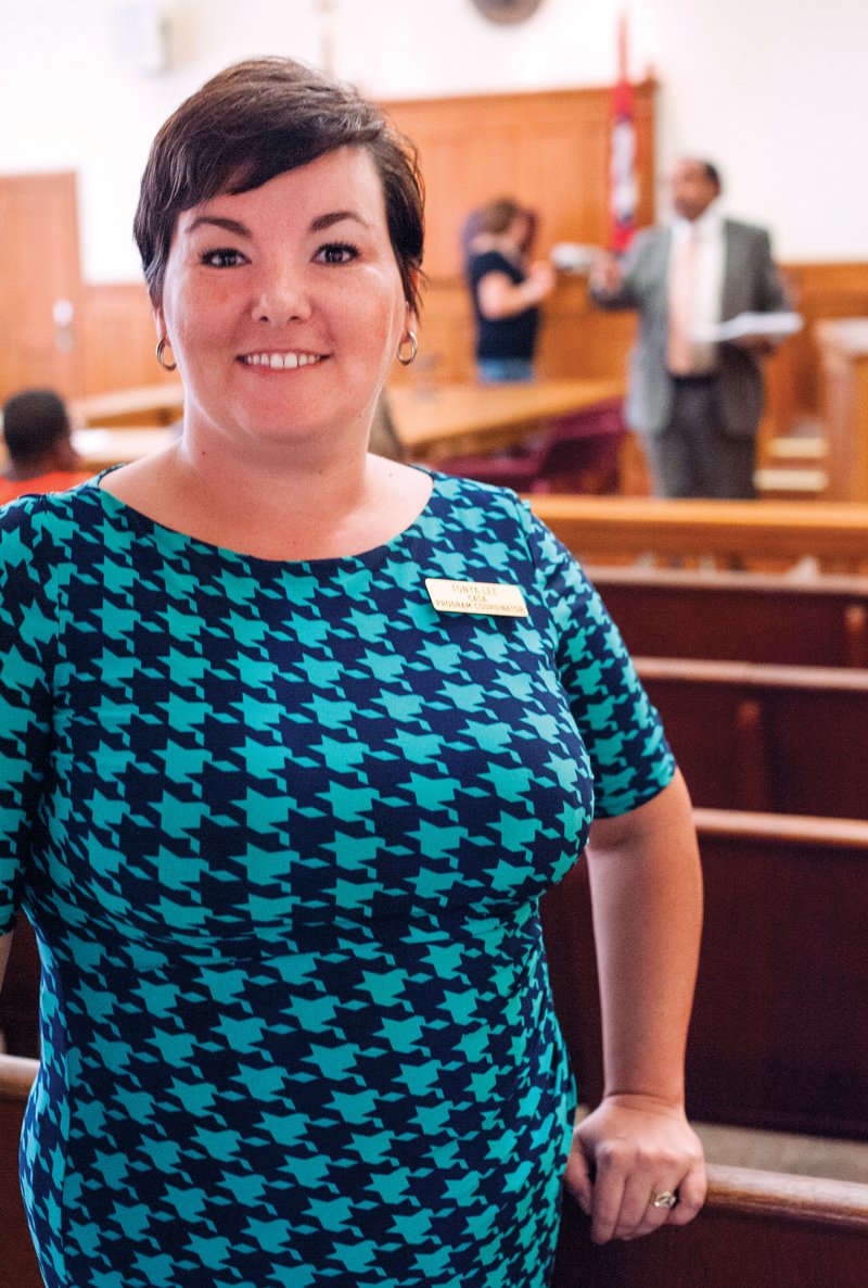 Tonya Lee, Hot Spring County program coordinator for the Court Appointed Special Advocates for children, or CASA, stands in the courtroom of the county courthouse where she and volunteers work with children whose lives have become entangled in the legal system.