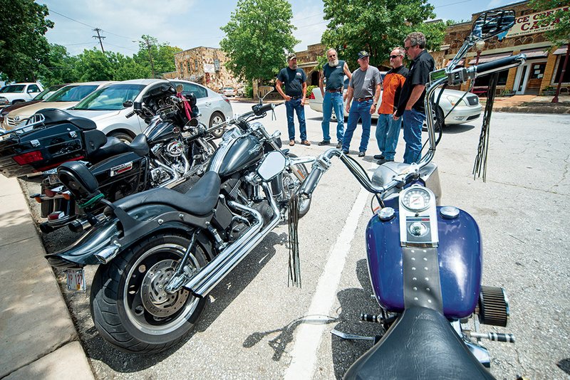 Richard Vaness, from left, Rick Hand, Grady Spann, Tim Winningham and Tim Gammill stand near their motorcycles on the square in Mountain View.
