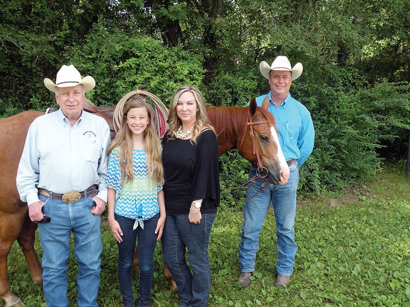 William Thomas “Bill” Wallace, left, and his son, Jonathan Wallace, right, have been selected the 2014 Faulkner County Farm Family of the Year. Jonathan’s family includes his wife, Kelly, third from the left, and their daughter, Courtney, second from the left; they also have a son, Cody. The Wallaces raise cattle and hay at the Braveheart Cattle Co. near Mount Vernon. Both men competed in rodeos and work their cattle from horseback.